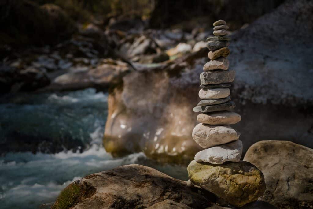 stones stacked along river - you need balance