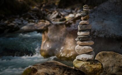 stones stacked along river - you need balance