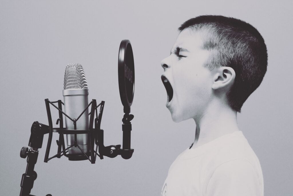 young child yelling into microphone