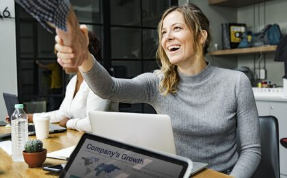 woman smiling and shaking hands