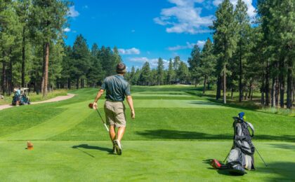 man watching drive down fairway