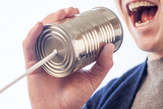 person with tin can telephone depicting find prospects for mlm step 2 communication.