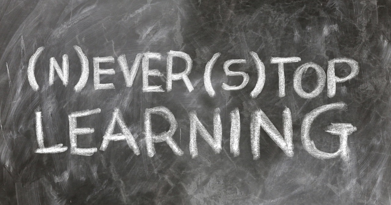 text: never stop learning written on a blackboard