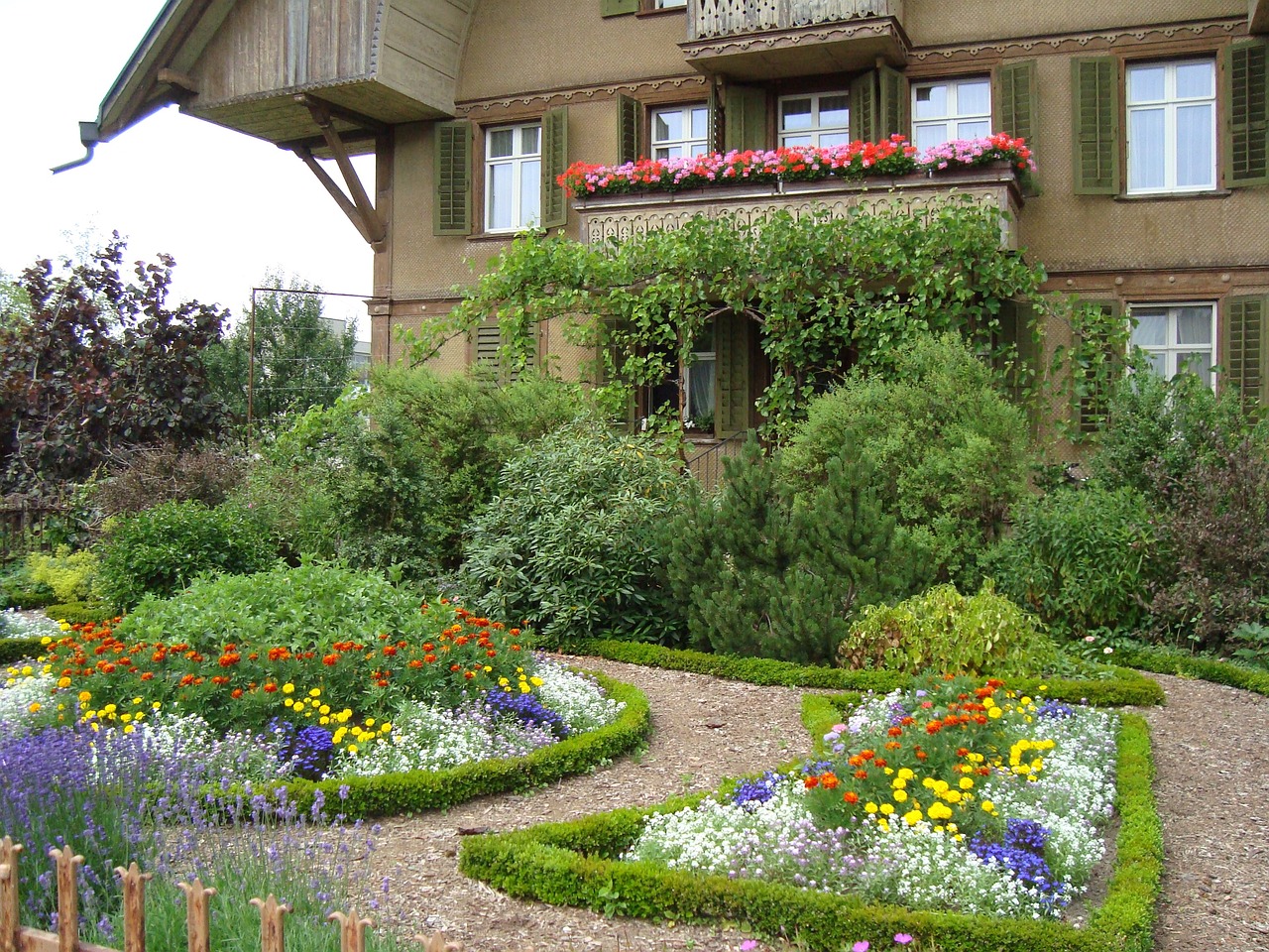 two story european house with cottage garden in front