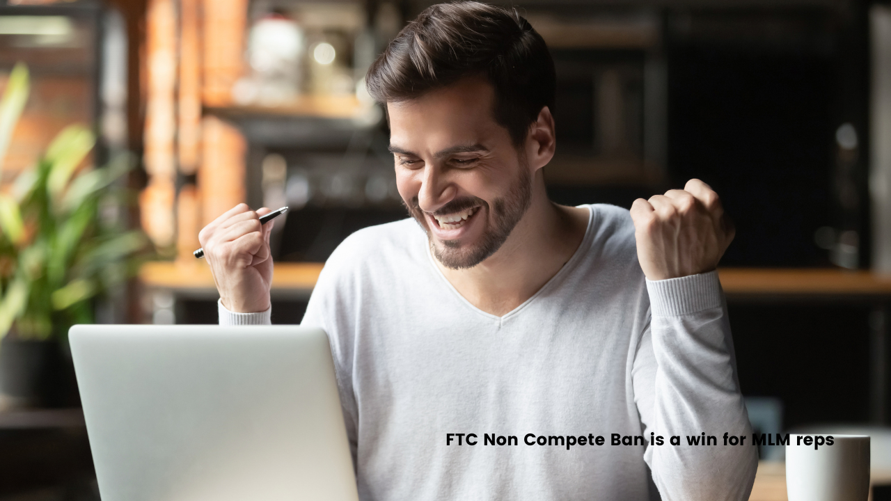 The FTC non compete ban is an overall win for MLM reps. Man sitting at laptop with excited fist-pumping.